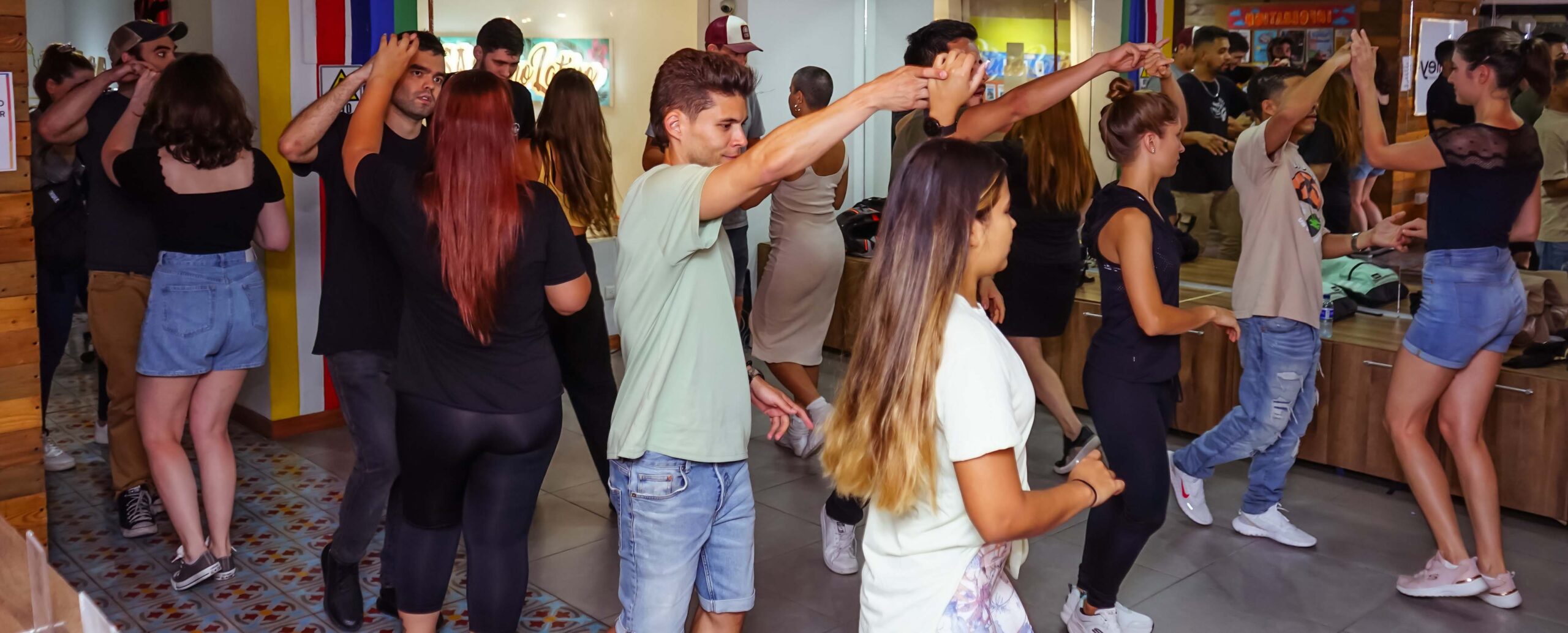 Students practicing partner dance in a group class